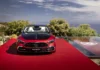 Mercedes-Maybach SL 680 South Africa: R5m pricing revealed Front view of the red Mercedes-Maybach SL 680 Monogram Series roadster on a red stage overlooking the ocean, displaying the chrome grille and upright bonnet star.