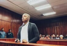 Shebeshxt bail appeal postponed over AI papers – may cost him weeks or more in jail Shebeshxt speaks into a courtroom microphone at Polokwane High Court during his AI-papers bail appeal, showing face and neck tattoos.