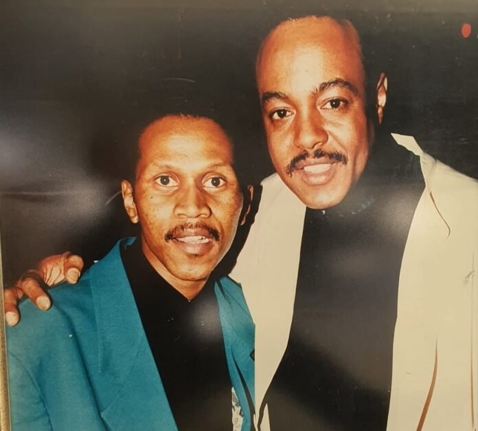 Vintage photograph of R&B singer Peabo Bryson smiling with South African radio legend Earnest Pillay.