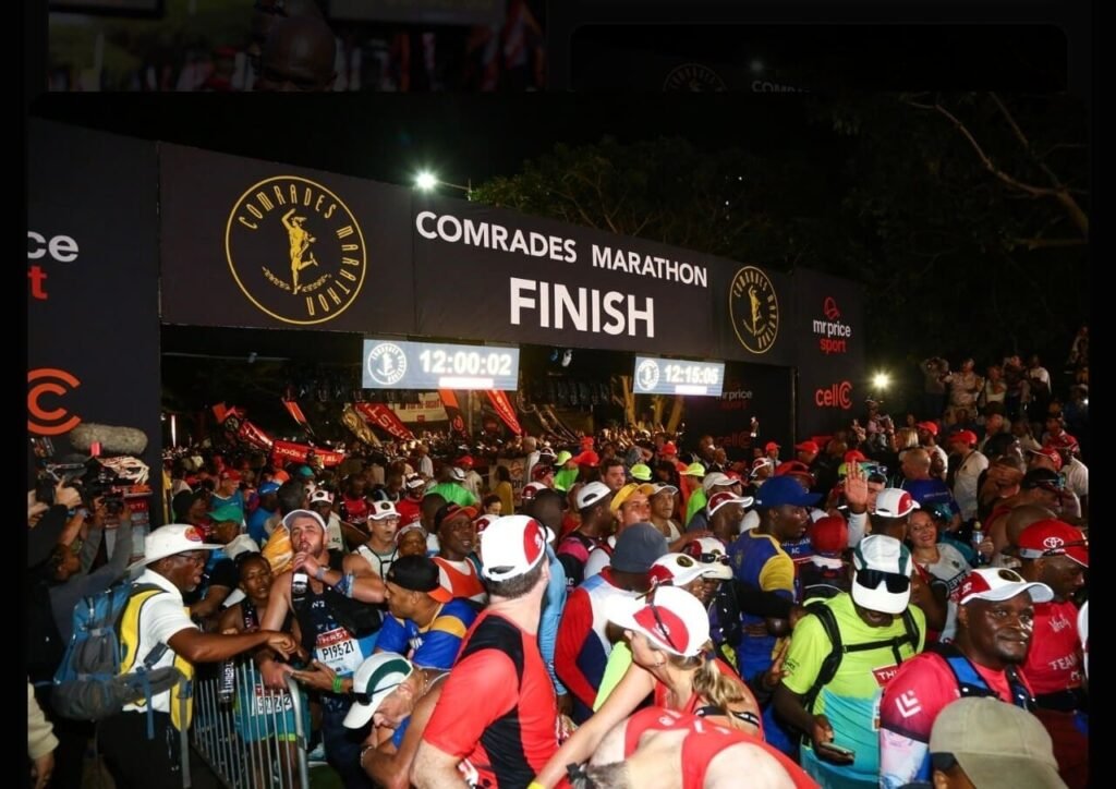2025 Comrades Marathon finish line crowd at Scottsville shows heavy race day congestion on Durban-Pietermaritzburg route.