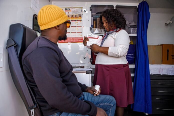 Gauteng Lenacapavir HIV prevention injection rollout: healthcare worker and patient in Soweto mobile clinic.