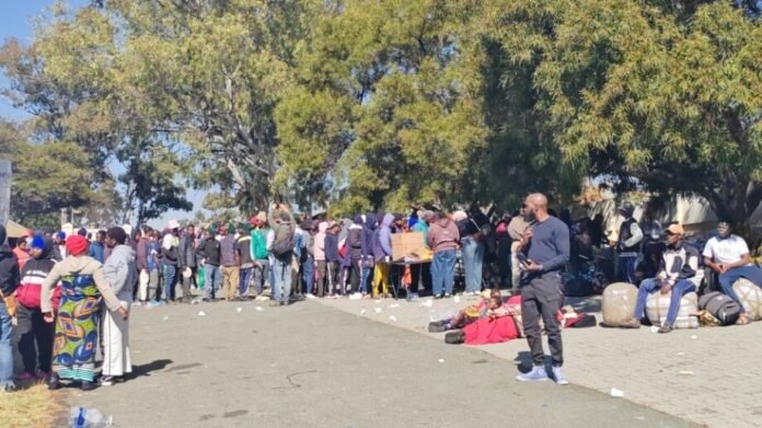 Hundreds of Malawian nationals wait outside the Sandton Consulate for voluntary repatriation on June 30, 2026.