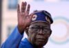 Nigeria repatriation 2026: 1,094 volunteers – who qualifies and how to register now Nigeria President Bola Tinubu raises his hand during a public appearance amid Nigeria's 2026 repatriation programme