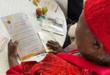 Urgent action for SASSA recipients under review for August payments: Documents required to verify eligibility A SASSA beneficiary reviews a Child Support Grant document during a community outreach session.