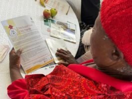 Urgent action for SASSA recipients under review for August payments: Documents required to verify eligibility A SASSA beneficiary reviews a Child Support Grant document during a community outreach session.