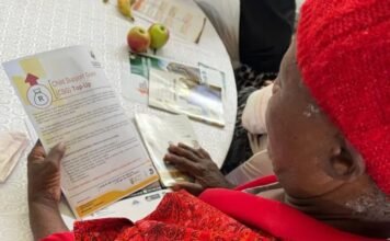 Urgent action for SASSA recipients under review for August payments: Documents required to verify eligibility A SASSA beneficiary reviews a Child Support Grant document during a community outreach session.