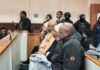 WATCH: SAPS stops Imogen Mashazi from handing a jacket to the court gallery Imogen Mashazi and three co-accused sit in the Germiston Magistrate's Court as SAPS officers stand behind them.