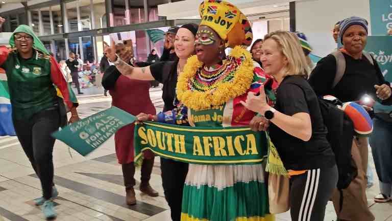 Mama Joy poses with supporters during Banyana Banyana's WAFCON airport send-off.