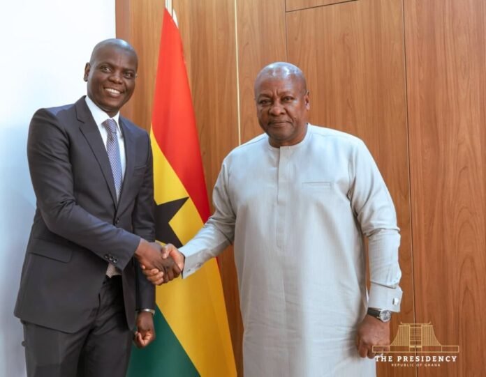 Ronald Lamola shakes hands with Ghana President John Mahama during a meeting in Accra, with Ghana's national flag behind them.