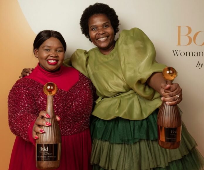 Pretty Kubyane and Lindiwe Nkuna-Kgopa pose with their 2026 Veuve Clicquot Bold Woman Award trophies.