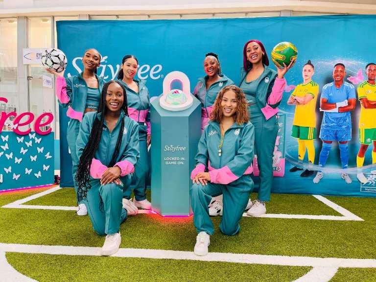 Banyana Banyana and Stayfree representatives pose around a branded display during the Goals 4 Pads campaign.