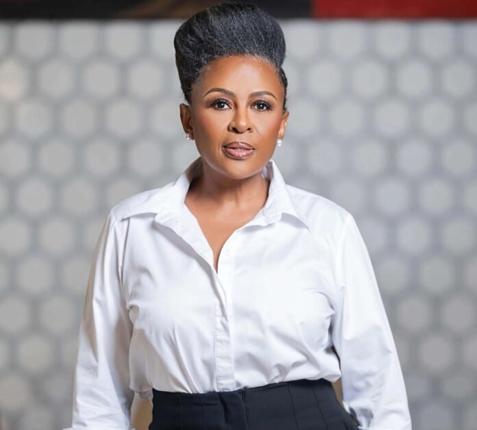 Basetsana Kumalo in a white shirt and black trousers during her 30-year business career
