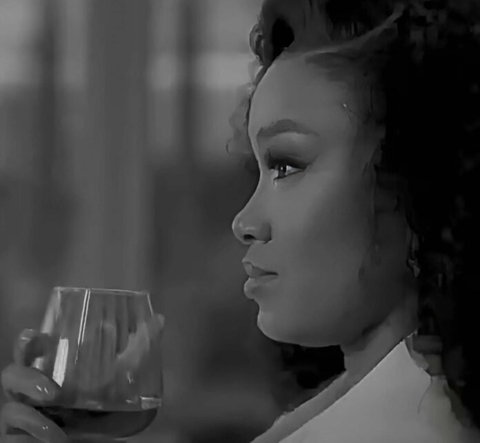 Dineo Langa holds a whisky glass in a screenshot from the deleted Glenlivet advert video.