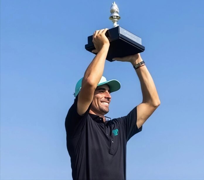 Joaquín Niemann holds the LIV Golf New York trophy above his head after winning at Bedminster.