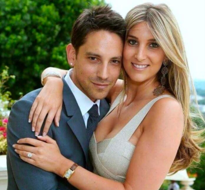 Lisa Koppel embraces Danny K as the couple smile together for a photograph.
