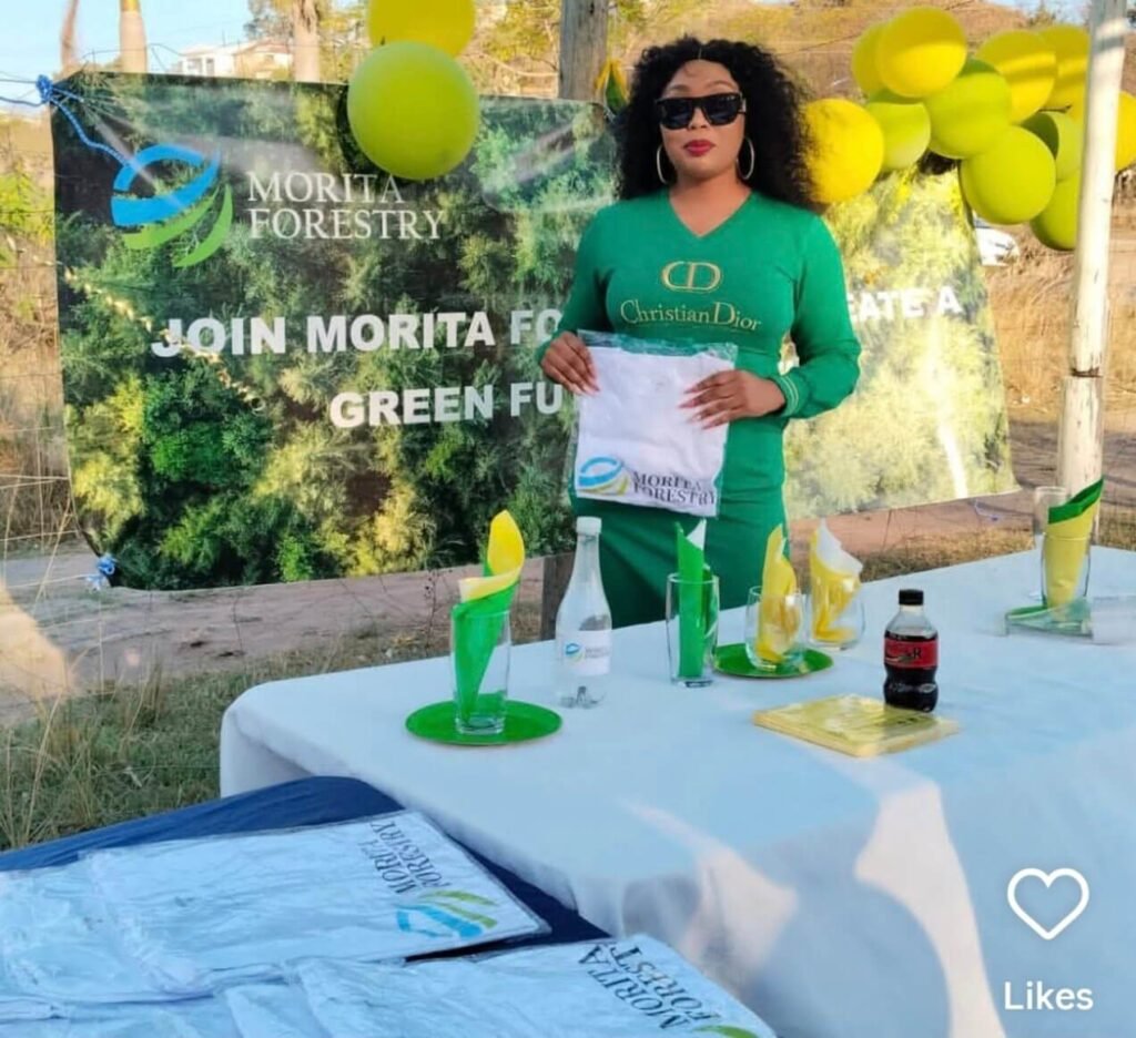Recruiter speaks at a Morita Forestry promotional event beside company branding.