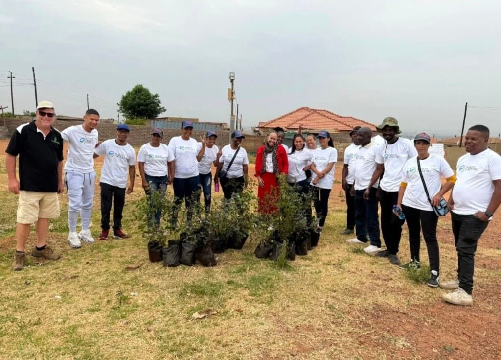 Participants gather with young trees during an early Morita Forestry tree-planting event.