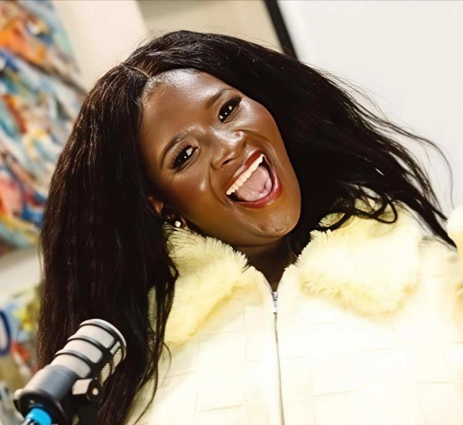 Natasha Fuyane smiles beside a podcast microphone. She delivered a tribute to Nothabo at the Bulawayo funeral.
