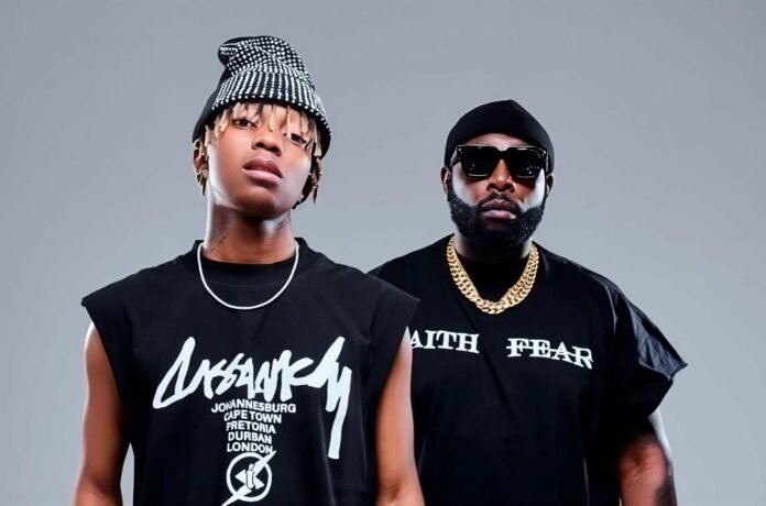 DJ Maphorisa and Xduppy stand side by side in black outfits against a grey background.