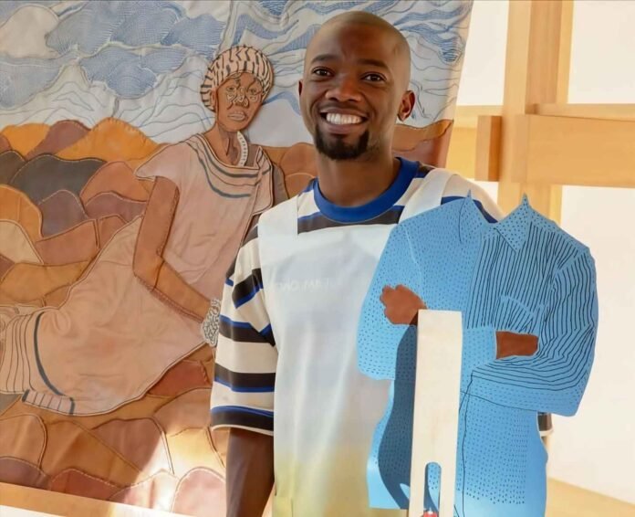Abongile Sidzumo stands beside his artwork for the Absa L’Atelier 40 Doors Legacy event
