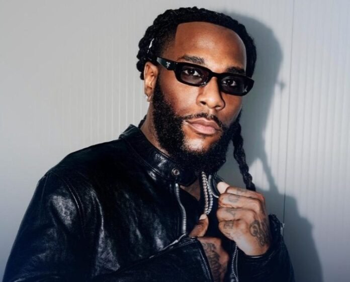 Burna Boy poses in sunglasses ahead of his NFL Paris Game halftime show
