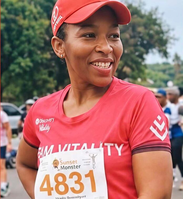 Elizabeth Moselakgomo in red running gear at an outdoor race