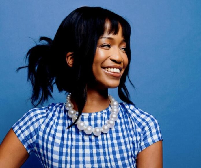 Lusanda, Spotify EQUAL Africa Ambassador, smiling in blue gingham top