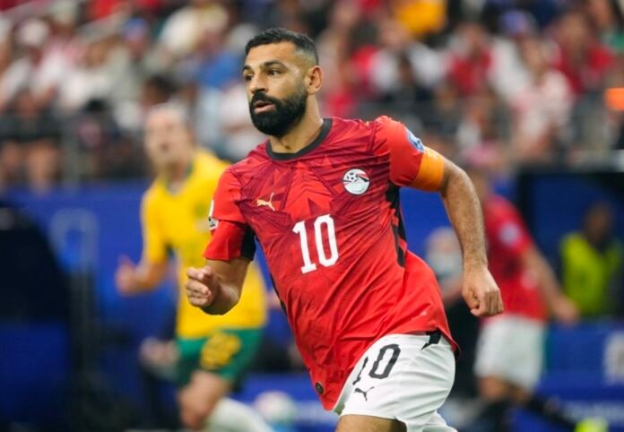 Mohamed Salah of Egypt running in a red Egypt jersey during a match.