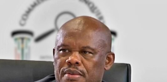 Sibiya faces rape, trafficking and grooming charges: a timeline of the allegations Lt-Gen Shadrack Sibiya in a dark suit seated before a blurred Commission of Inquiry backdrop