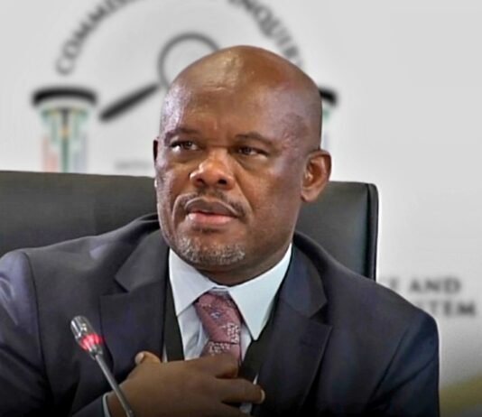 Sibiya faces rape, trafficking and grooming charges: a timeline of the allegations Lt-Gen Shadrack Sibiya in a dark suit seated before a blurred Commission of Inquiry backdrop