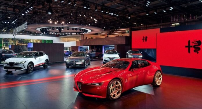 Red Alfa Romeo Cuorerosso concept car on display at the 2026 Paris Motor Show, surrounded by other Alfa models.