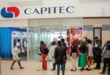 Capitec name change gazetted: what it means for everyday customers Customers queue outside a Capitec branch with ATMs and a red hello display inside a shopping centre
