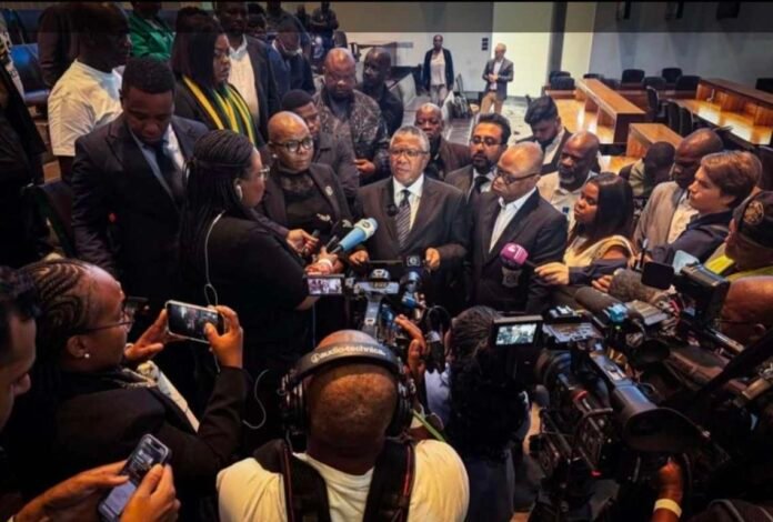 Fikile Mbalula addresses journalists surrounded by cameras and microphones after the ANC's Constitutional Court victory.