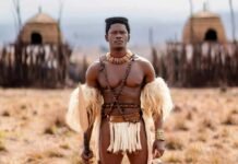 Shaka iLembe goes global as Season 3 first look is revealed Lemogang Tsipa as King Shaka in Shaka iLembe, holding a spear before thatched huts in a dry grassland