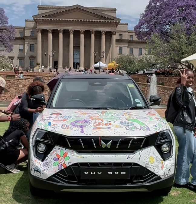 Students decorate a white Mahindra XUV 3XO with colourful doodles during the Fusion Fest activation at Wits.