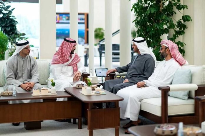 Four Gulf leaders in traditional dress hold talks on cream sofas in a bright Abu Dhabi lounge.